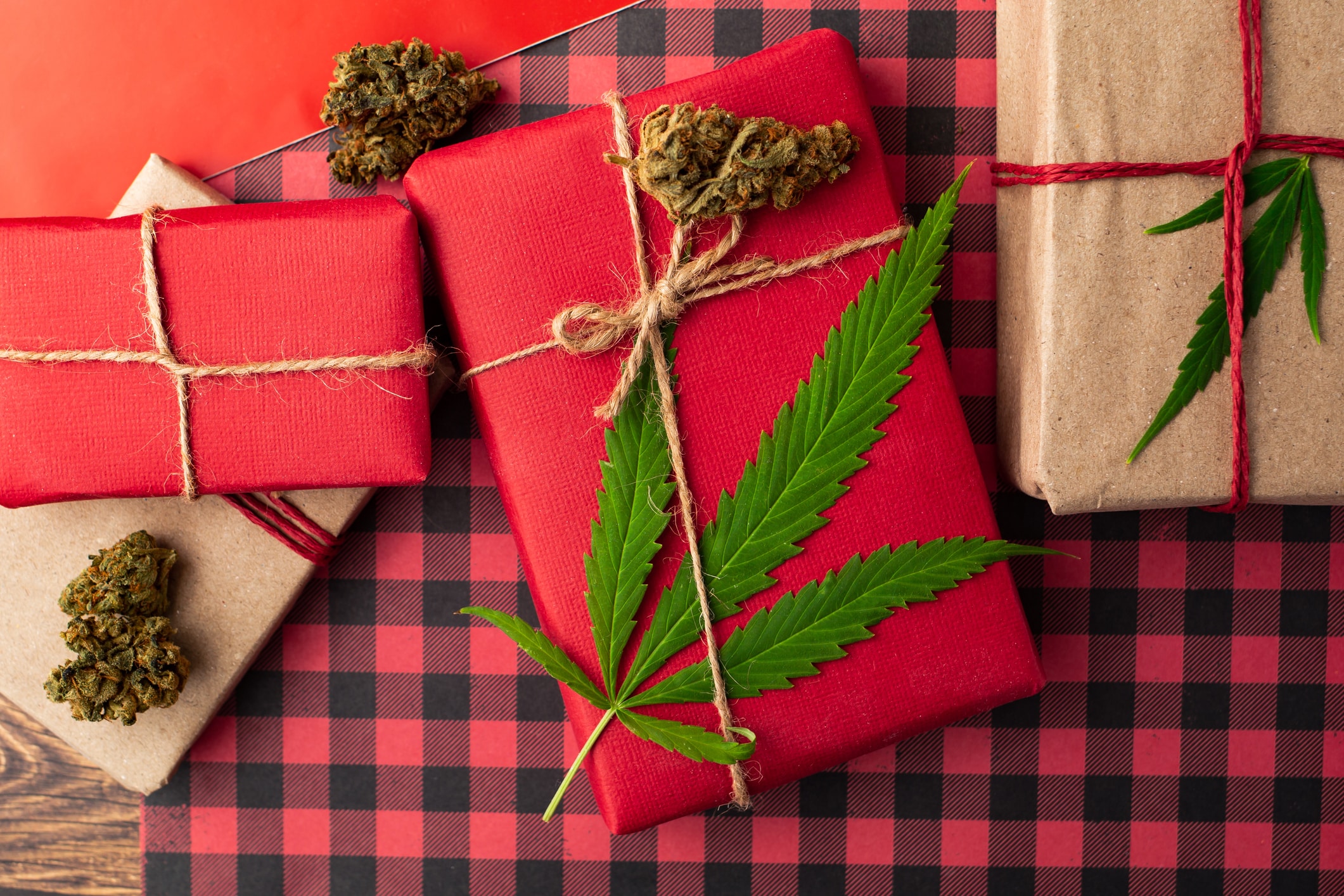 Red Christmas presents with cannabis leaf.