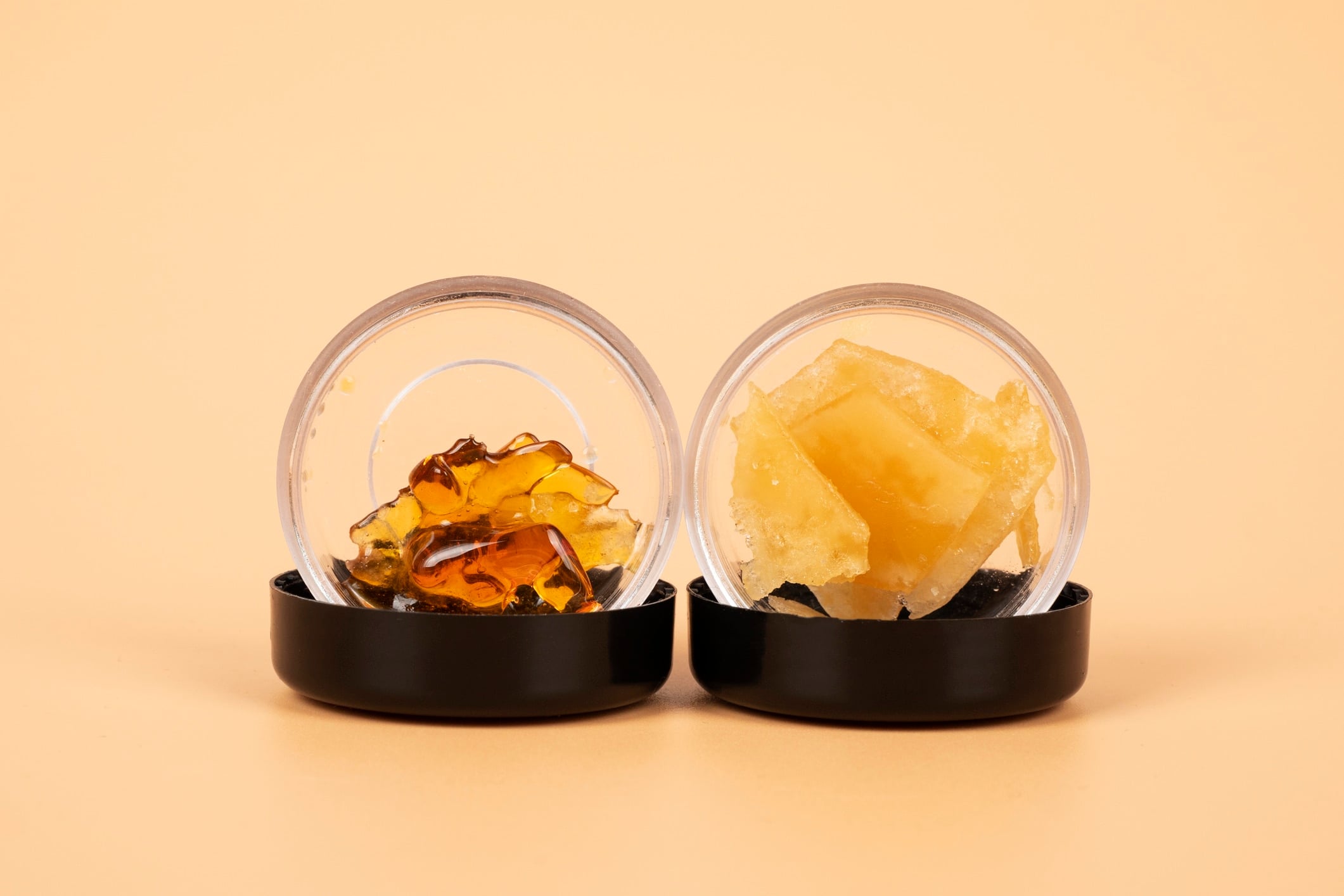 yellow extract wax from cannabis buds in container, marijuana thc distillate