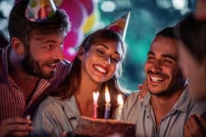 Group of friends celebrating birthday party outdoors.Concept of celebrating,people and happiness.