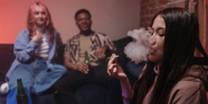GIRL SMOKING WEED IN A ROOM WITH A BOY AND A GIRL
